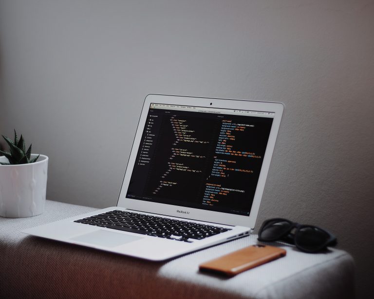 Desk with a mac and data