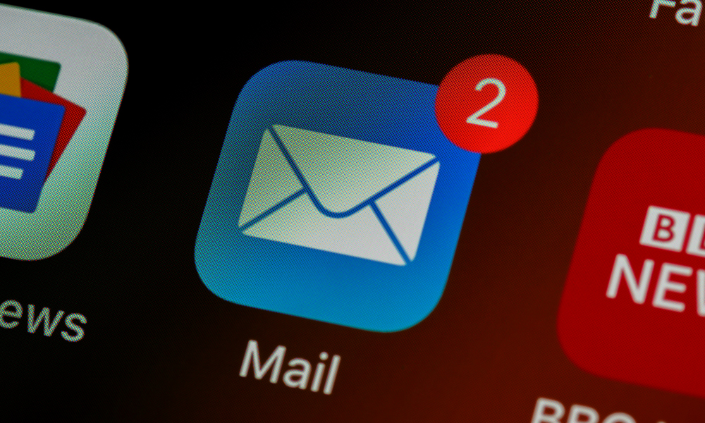 **Alt Text:** Close-up of a smartphone screen displaying an email app icon with a notification badge, symbolizing the evolution of email marketing in 2025 and its continued relevance as a powerful communication channel.